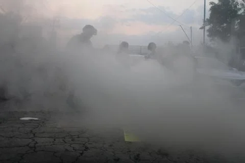 Cop puts fire in protest out Stock Photos