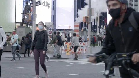 Cop standing in Time Square among the 2020 Biden presidential win Stock Footage 142724177