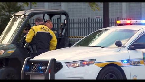Cop talking to other cops in street Stock Footage 147223799