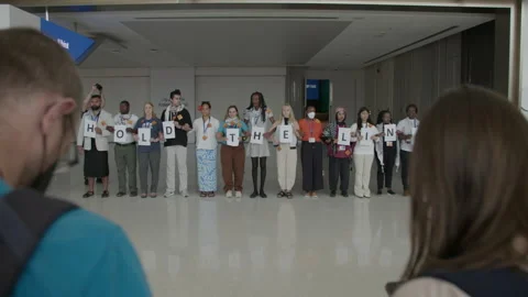 COP28, Dubai: A chain of demonstrators hold the letters to “hold the line” Stock Footage 288467384