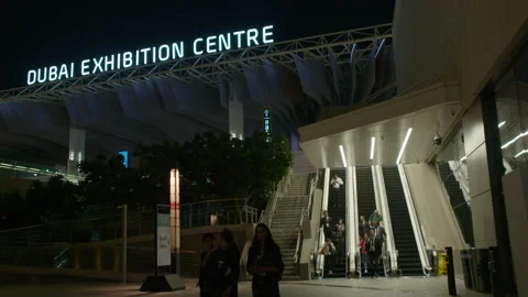 COP28, Dubai: Escalators outside the Dubai Exhibition Centre, by night Stock Footage 289646589