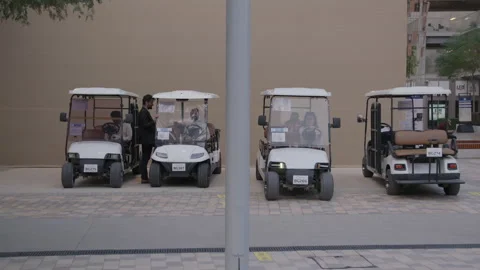 COP28, Dubai: Four carts are parked, one of them drives off Stock Footage 289633665