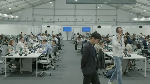 COP28, Dubai: Journalists working at press and media center 動画素材 289641111