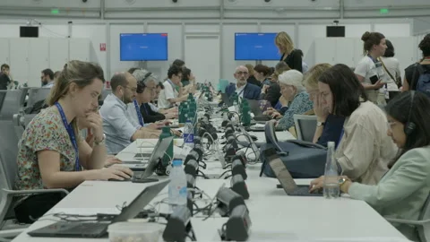 COP28, Dubai: Journalists working at press and media center Stock Footage 289641571