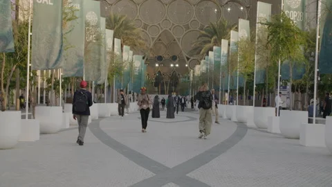 COP28, Dubai: People walking down the street in front of the expo city dome 動画素材 289553249