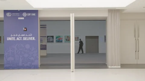 COP28, Dubai: A security guard walks into a room with exposed paintings Stock Footage 289642070