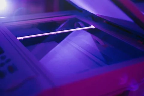 Copier scanner with a bright light inside. Office hazards Stock Photos