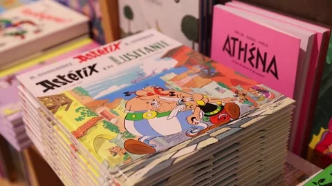 Copies of the new comic book 'Asterix in Lusitania' now on sale in a bookstore i Vídeo Stock 319758780
