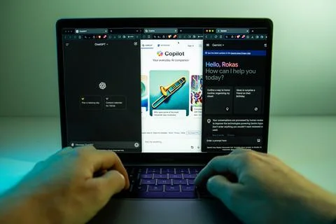 Copilot, ChatGPT, Gemini AI chatbots opened on separated windows on laptop Stock Photos