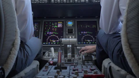 Copilot Pressing a Button in the Center Console of a Plane Stock Footage 208753431