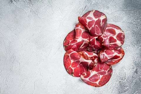 Coppa Cured ham on kitchen table. White background. Top view. Copy space Stock Photos