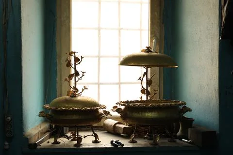 Copper accessories standing in front of the window Foto stock