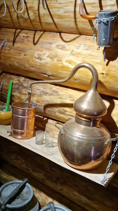 Copper Alembic Still Dripping in Rustic Log Cabin Stock Footage 318346932