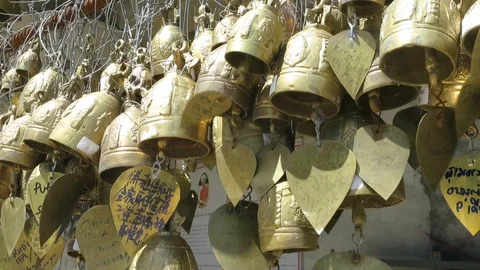Copper bells with messages ring in the wind at the temple Stock Footage 114371812