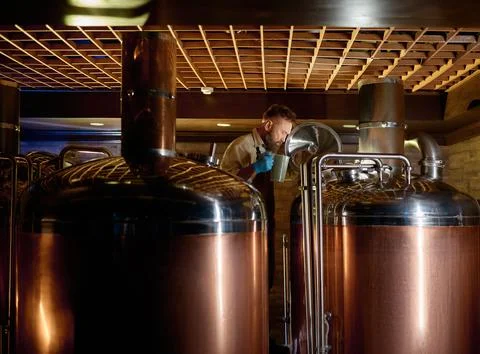 Copper boil kettle and distillery tanks in craft beer brewery Stock Photos