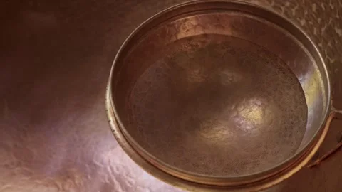 Copper bowl close up on metal surface with hammered texture Stock Footage 331195888