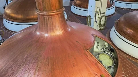 Copper brewing kettles inside a beer production facility, with polished metal Stock Footage 342663661
