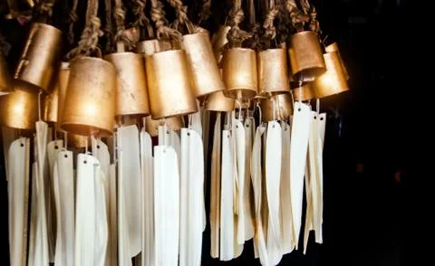 Copper can bell with mobile wind in dark Stock Photos