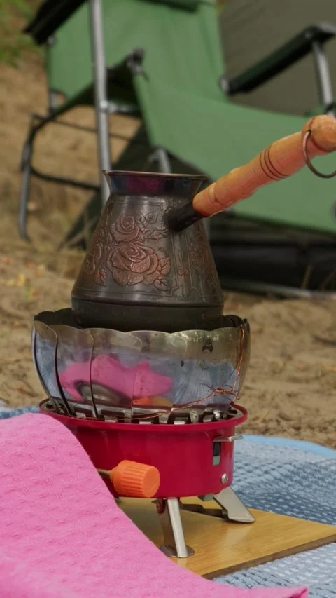 Copper Cezve Brewing Turkish Coffee on Portable Gas Stove at Campsite Stock Footage 341997270