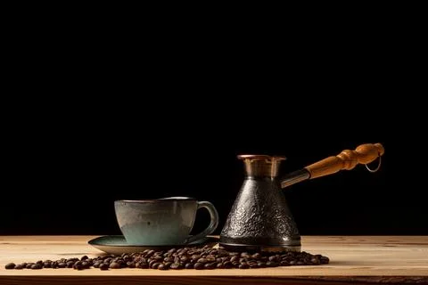 Copper cezve with coffee on the table Foto stock