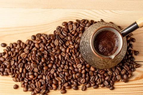Copper cezve with coffee on the table Foto stock