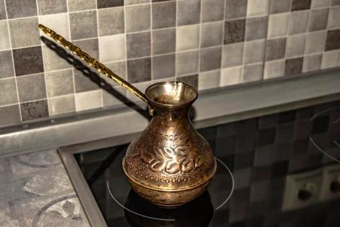 Copper cezve for making coffee to kitchen Stock Photos