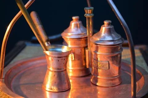 Copper coffee making facilities on a dark background at sunset Stock Photos