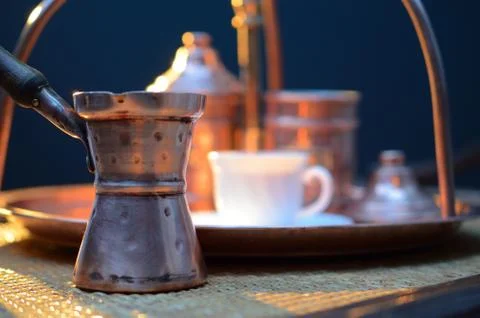 Copper coffee making facilities on a dark background at sunset Stock Photos