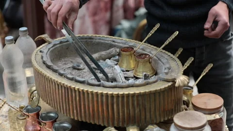 Copper coffee pot on hot embers. Making traditional Turkish coffee. Stock-Footage 144416984