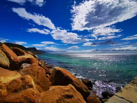 Copper colored rocks with blue sky Stock Photos