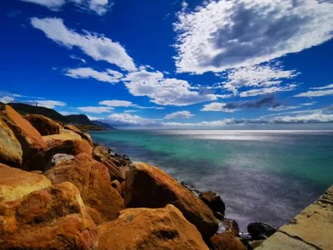 Copper colored rocks with blue sky Stock Photos