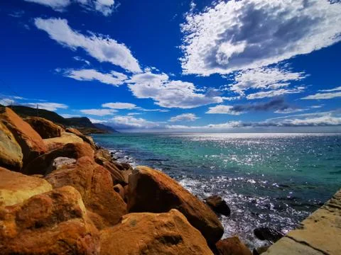 Copper colored rocks with blue sky Stock Photos