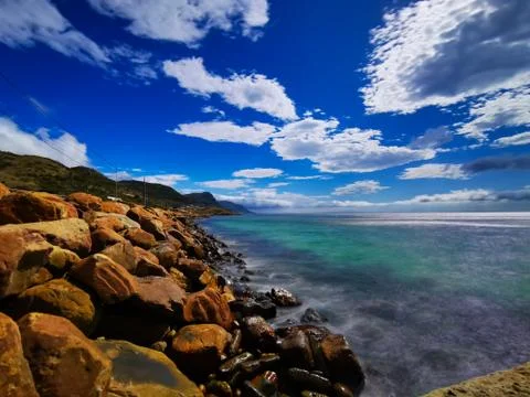 Copper colored rocks with blue sky Stock Photos