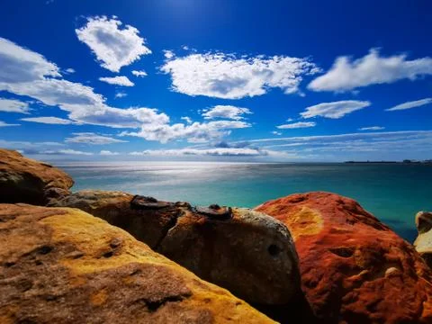 Copper colored rocks with blue sky Stock Photos