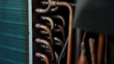 Copper cooling pipes inside appliance, Close-up of copper pipes and cooling.. Видео 338319439