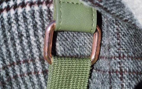 Copper fastening of a green backpack strap on a wool coat in close-up Stock-Fotos