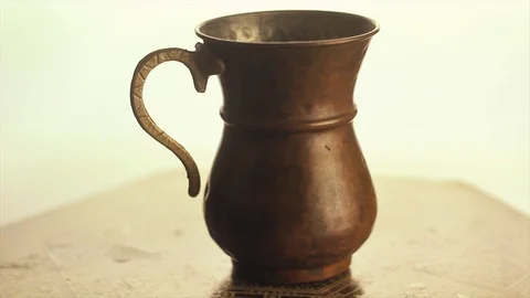 Copper glass is rotating in studio. Old, historic glass. Stock Footage 101592264