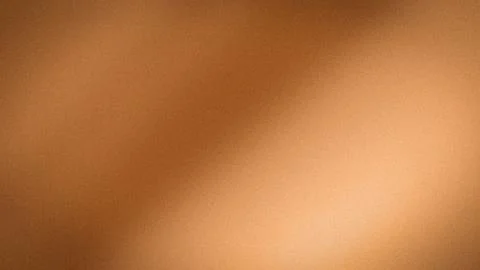 Copper gradient background with warm orange brown shades 4K abstract grainy.. Stock Photos