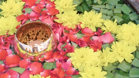 Copper jar with candle light floating on water decorate by petal rose Stock Footage 128642924