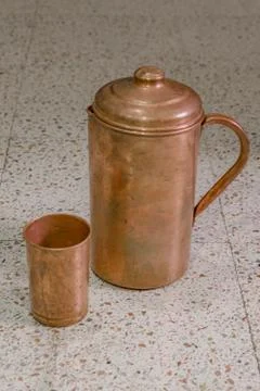 A copper jug and glass Stock Photos