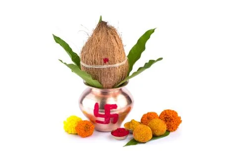 Copper Kalash with coconut, mango leaf, Haldi, kumkum and sweets with marigol Stock Photos