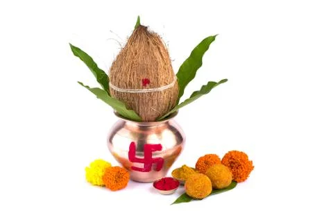 Copper Kalash with coconut, mango leaf, Haldi, kumkum and sweets with marigol Stock Photos