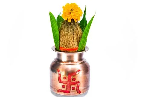 Copper kalash with coconut, mango leaf, and marigold flower Stock Photos