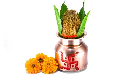 Copper kalash with coconut, mango leaf, and marigold flower Stock Photos