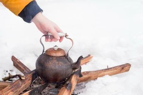 Copper kettle over an open fire in winter Stock Photos
