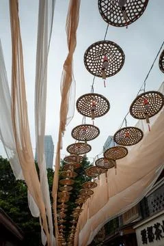 Copper lanterns hang from woven frames Stock Photos