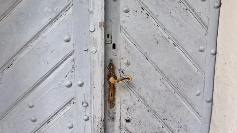 Copper Lock and Handle on Weathered Gray Historical Wooden Double Door Stock Footage 340248997