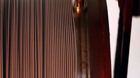 Copper metal electric wire rolling on a circular object Stock Footage 247116018