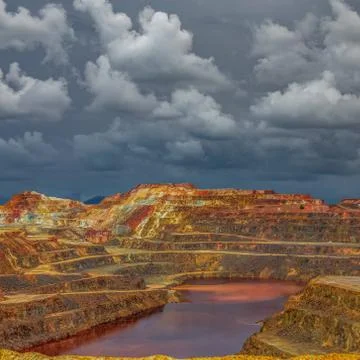 Copper mine with pond under the cloudscape Stock-Fotos