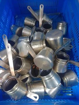 The copper mugs stack view in the basket Stock Photos